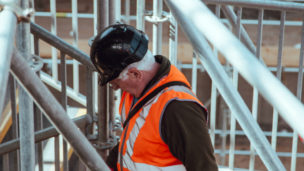 Construction worker in hard hat looking downward